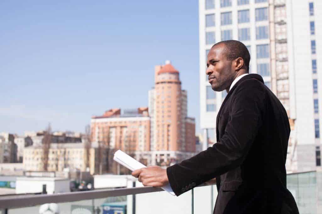 real estate professional standing in front of commercial building