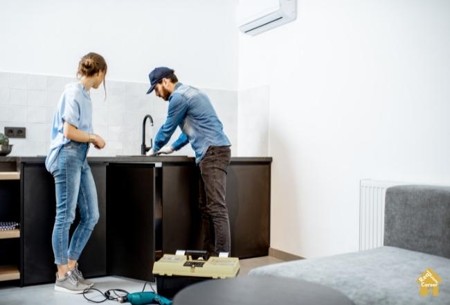 plumber fixing kitchen sink